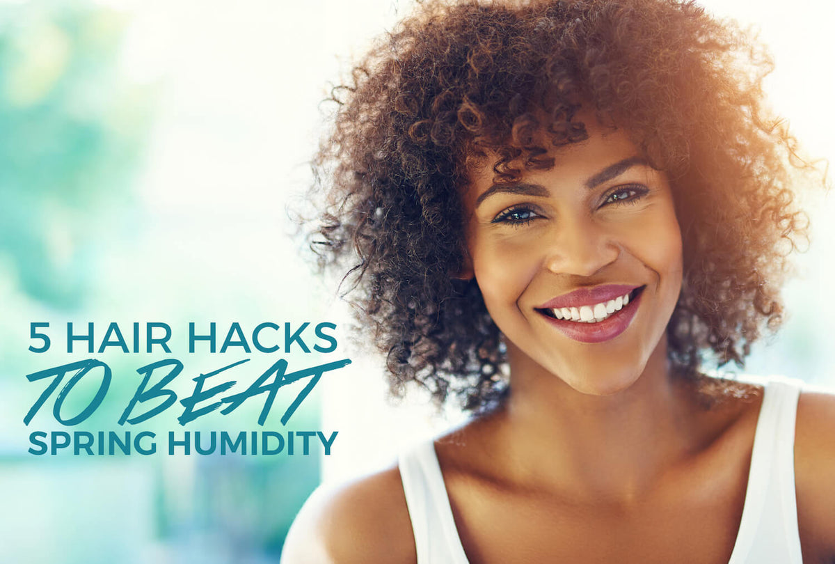 Black woman with defined natural curls resisting frizz on a humid spring day
