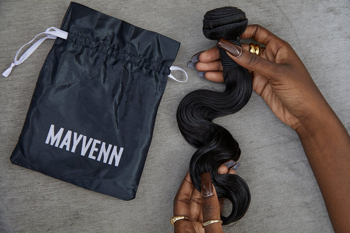 Synthetic and human hair extensions compared side by side on a surface