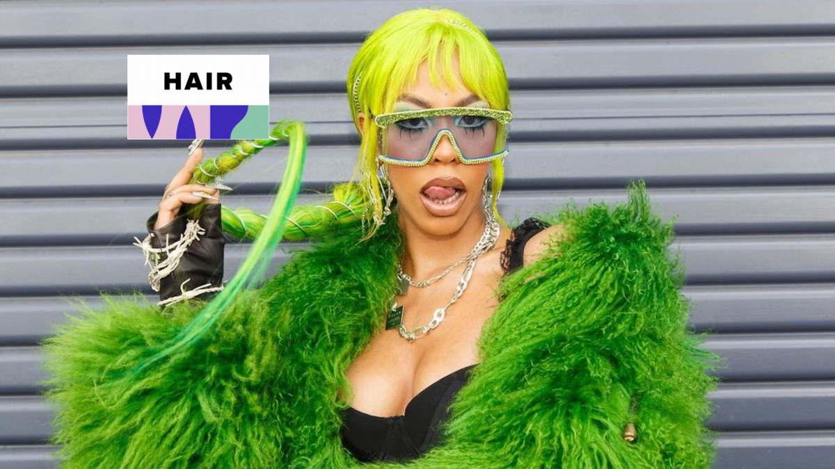 Rico Nasty wearing a brightly colored wig and bold makeup