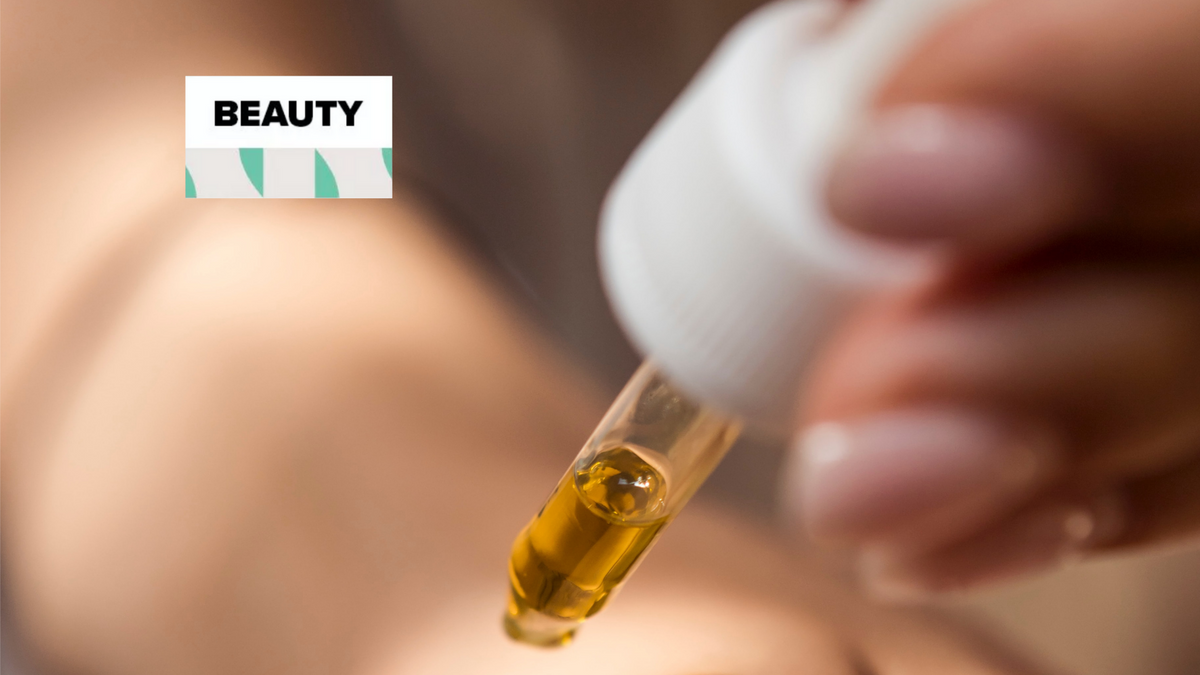 Retinol serum bottle placed beside a nighttime skincare routine
