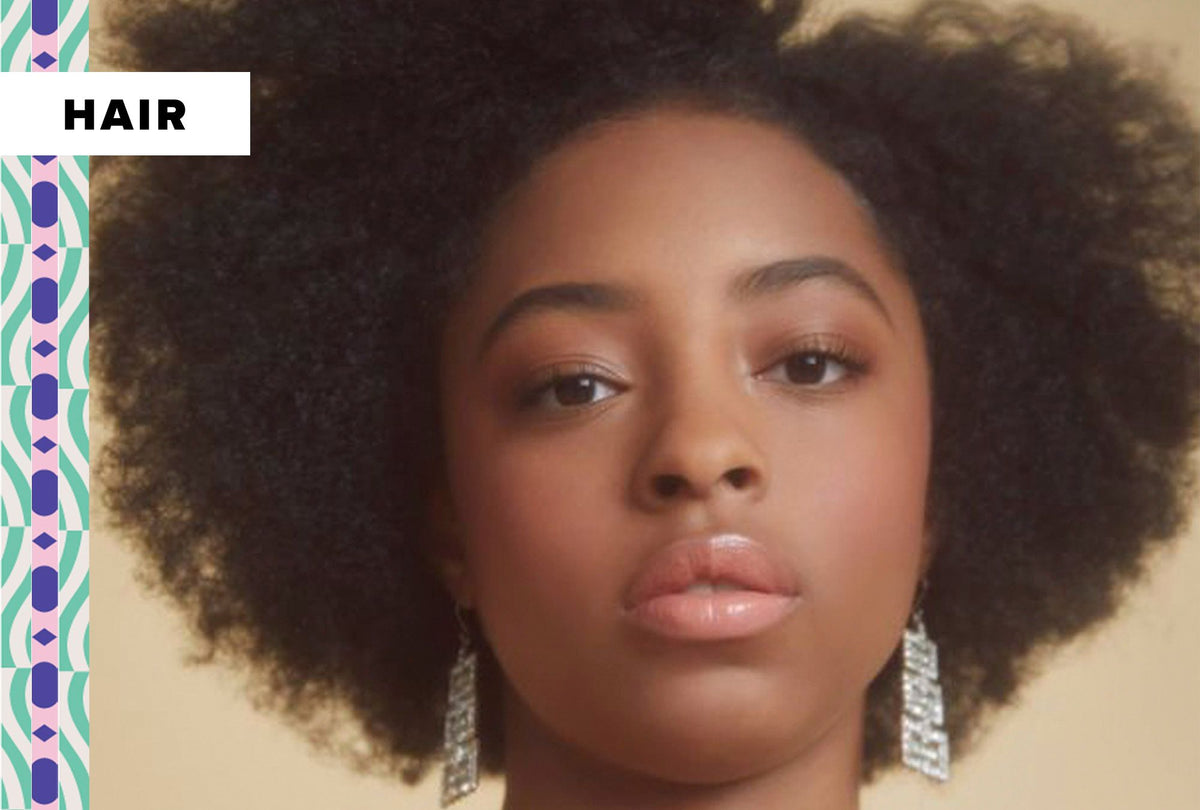Black woman wearing a protective style instead of her natural afro