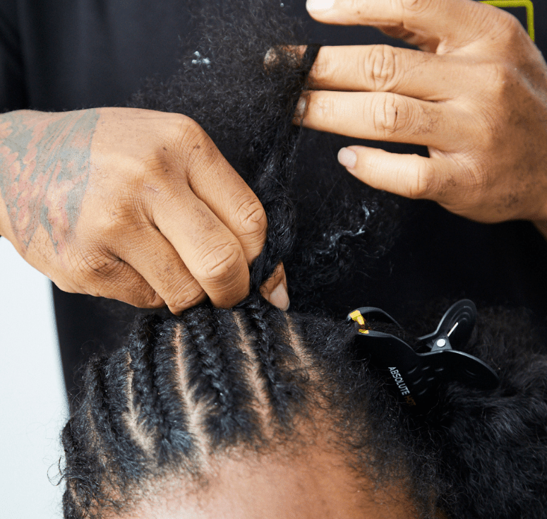 Woman examining a thinning hairline during Hair Loss Awareness Month