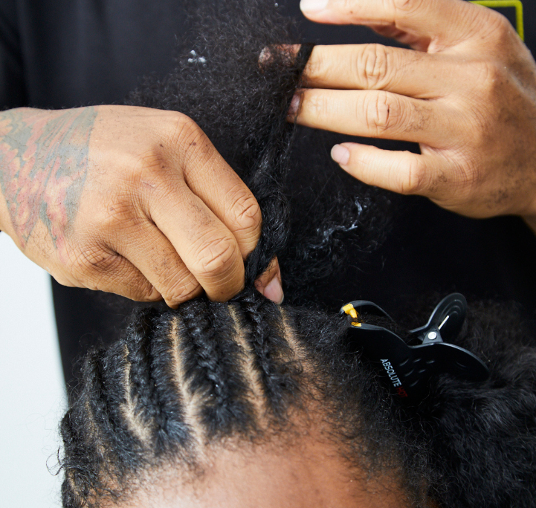 Woman examining a thinning hairline during Hair Loss Awareness Month