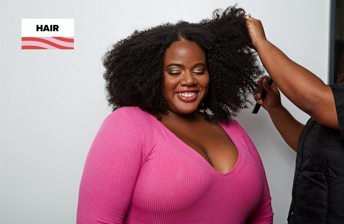 Stylist braiding down hair before reinstalling existing bundles