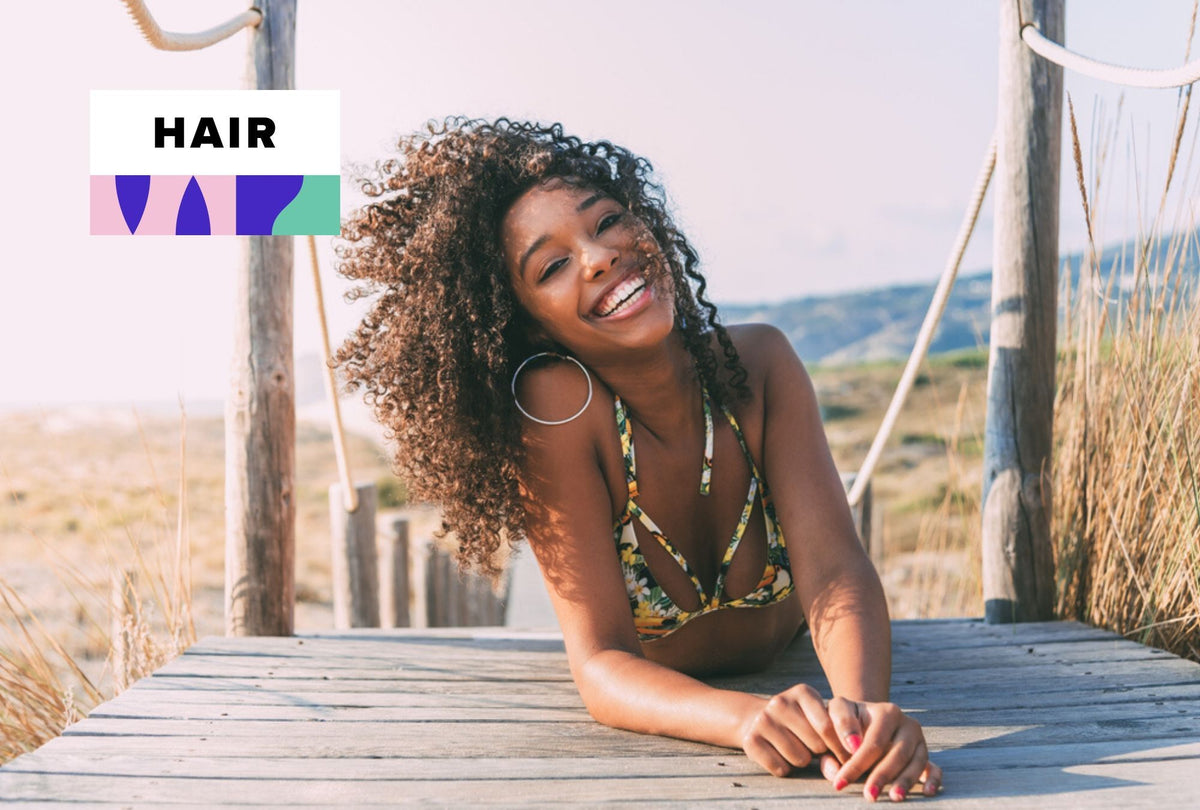 Human hair and synthetic wigs displayed side by side on wig stands
