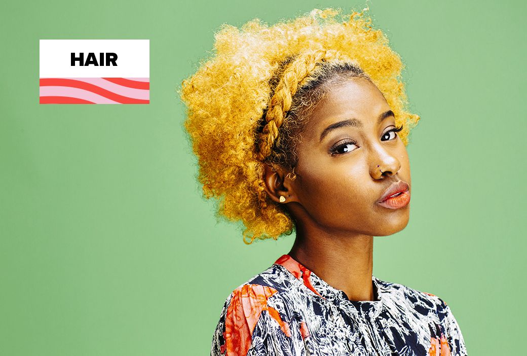 Young Black girl wearing her natural hair in puffs with confidence