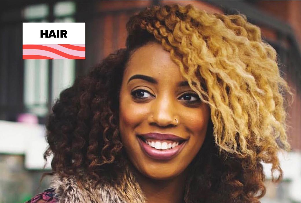 Woman deep conditioning her natural hair at home during lockdown