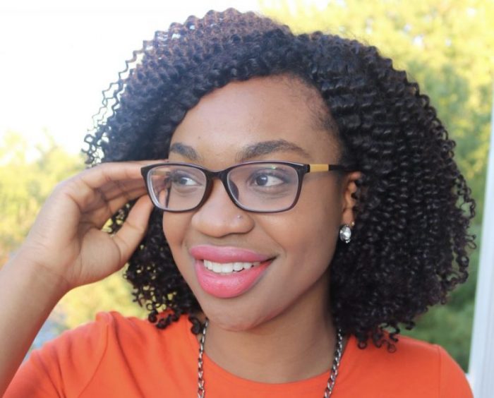 Woman wearing a homemade curly wig that needs adjusting at the cap