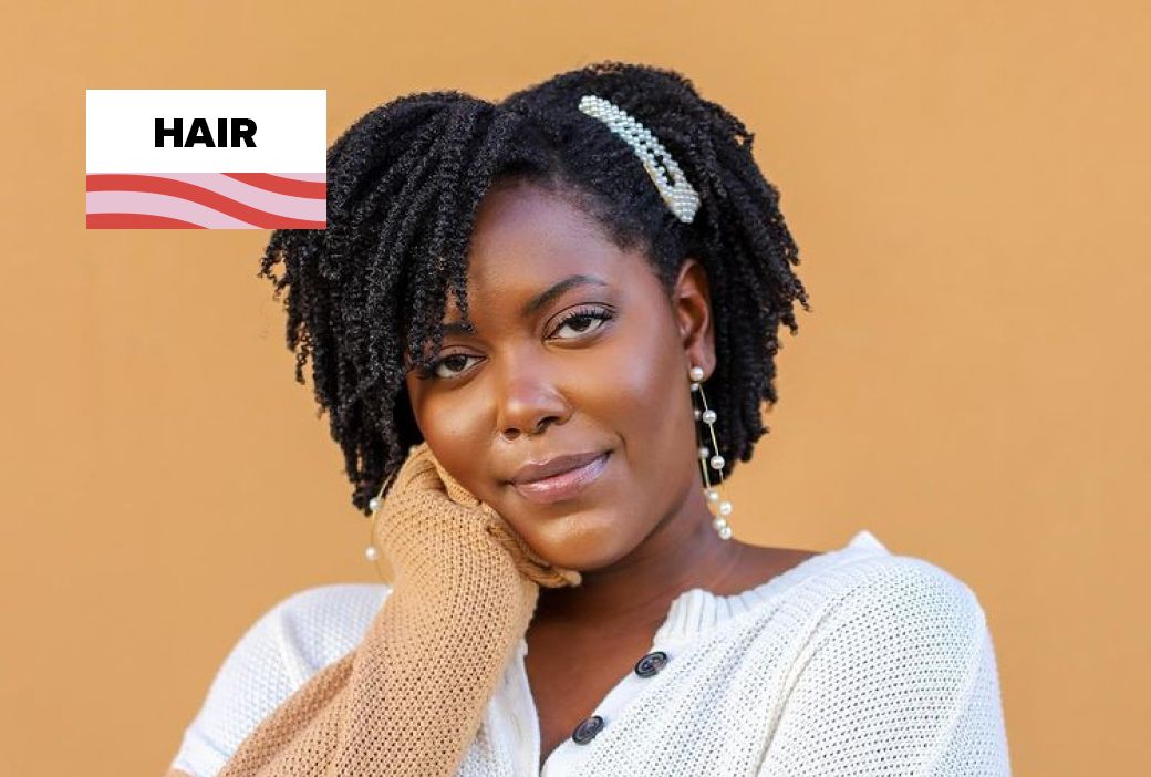 Natural hair content creator filming a styling video at home