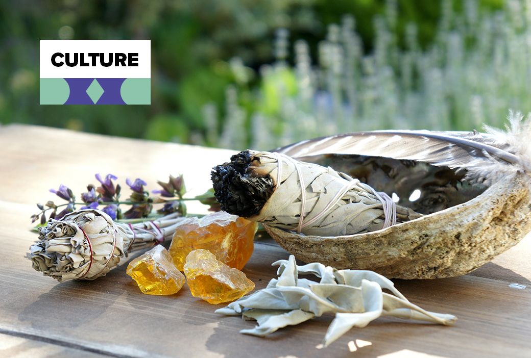 Candles and crystals set out for a grounding ritual at home