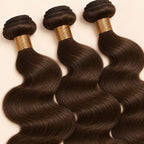 Three #2 chocolate brown body wave bundles angled to show the machine-sewn wefts