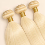 Three #613 blonde straight bundles angled to show the machine-sewn wefts