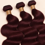 Three 99j burgundy body wave bundles angled to show the machine-sewn wefts
