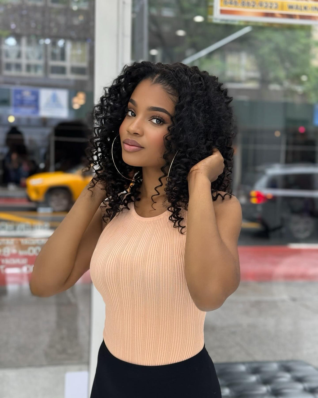 Brazilian deep wave hair falling in deep waves down the model's back