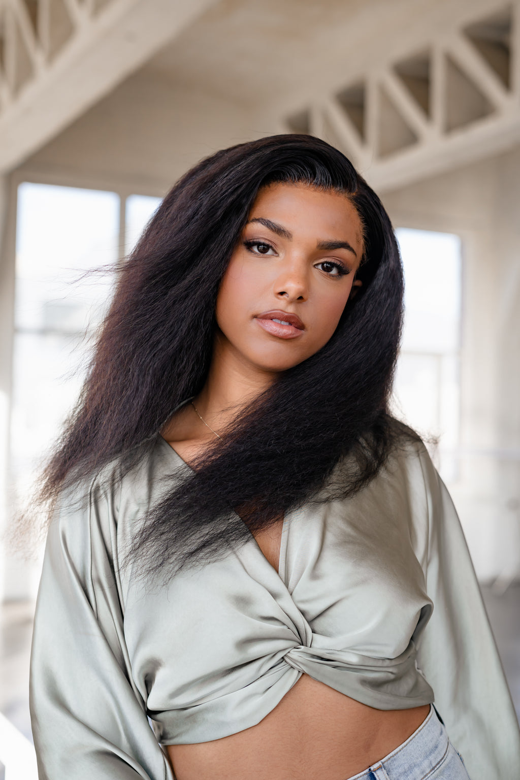 Model with a middle part kinky straight install styled full and long
