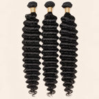 Three deep wave human hair bundles standing side by side