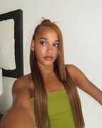 Seamless clip-in wefts arranged on a flat surface by length