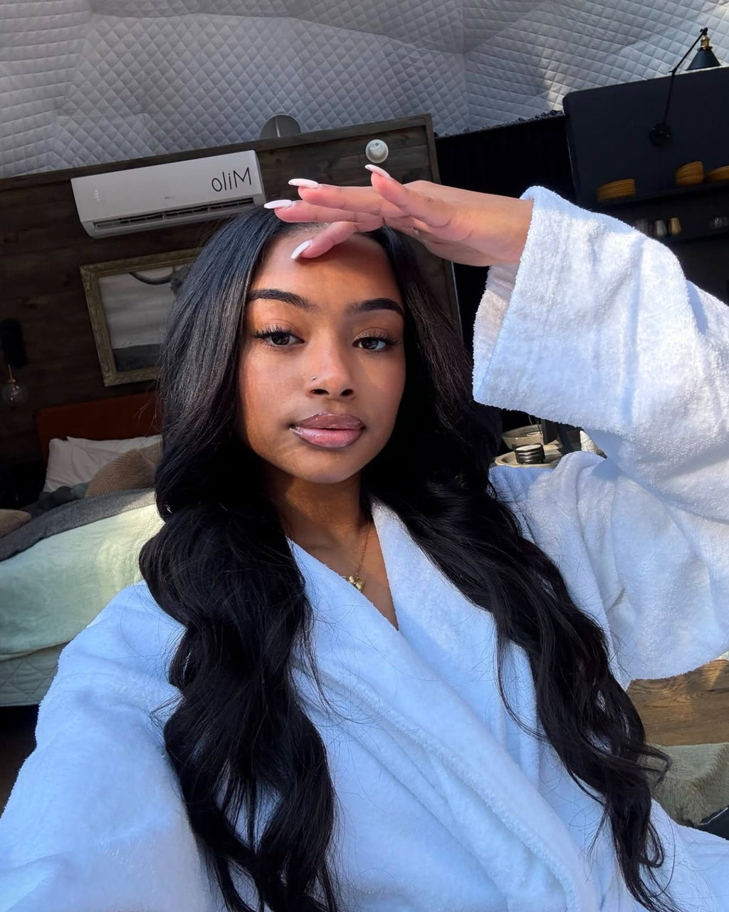 Natural black Malaysian body wave bundle coiled on a plain background