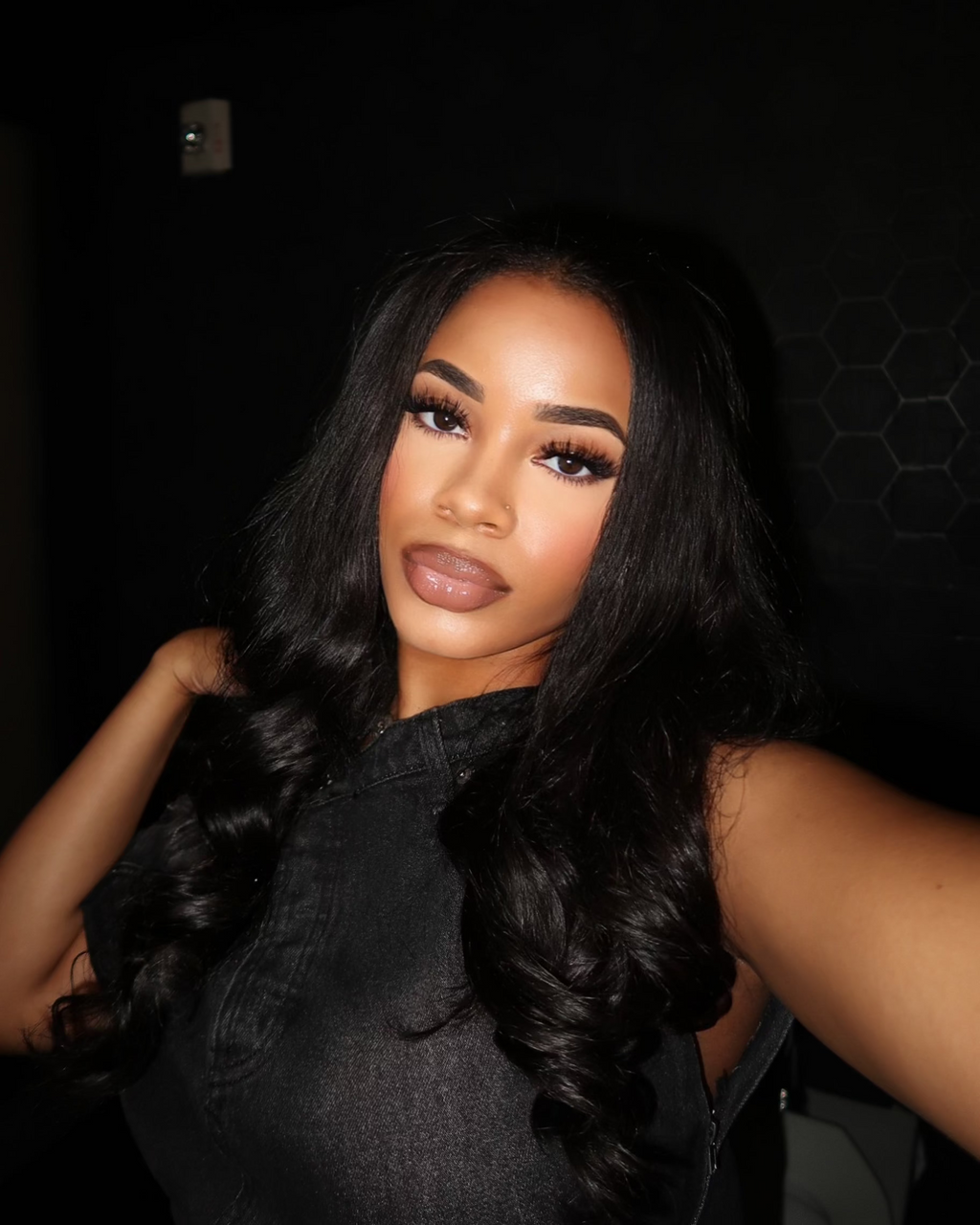 Three natural black Malaysian body wave bundles stacked for a full sew-in