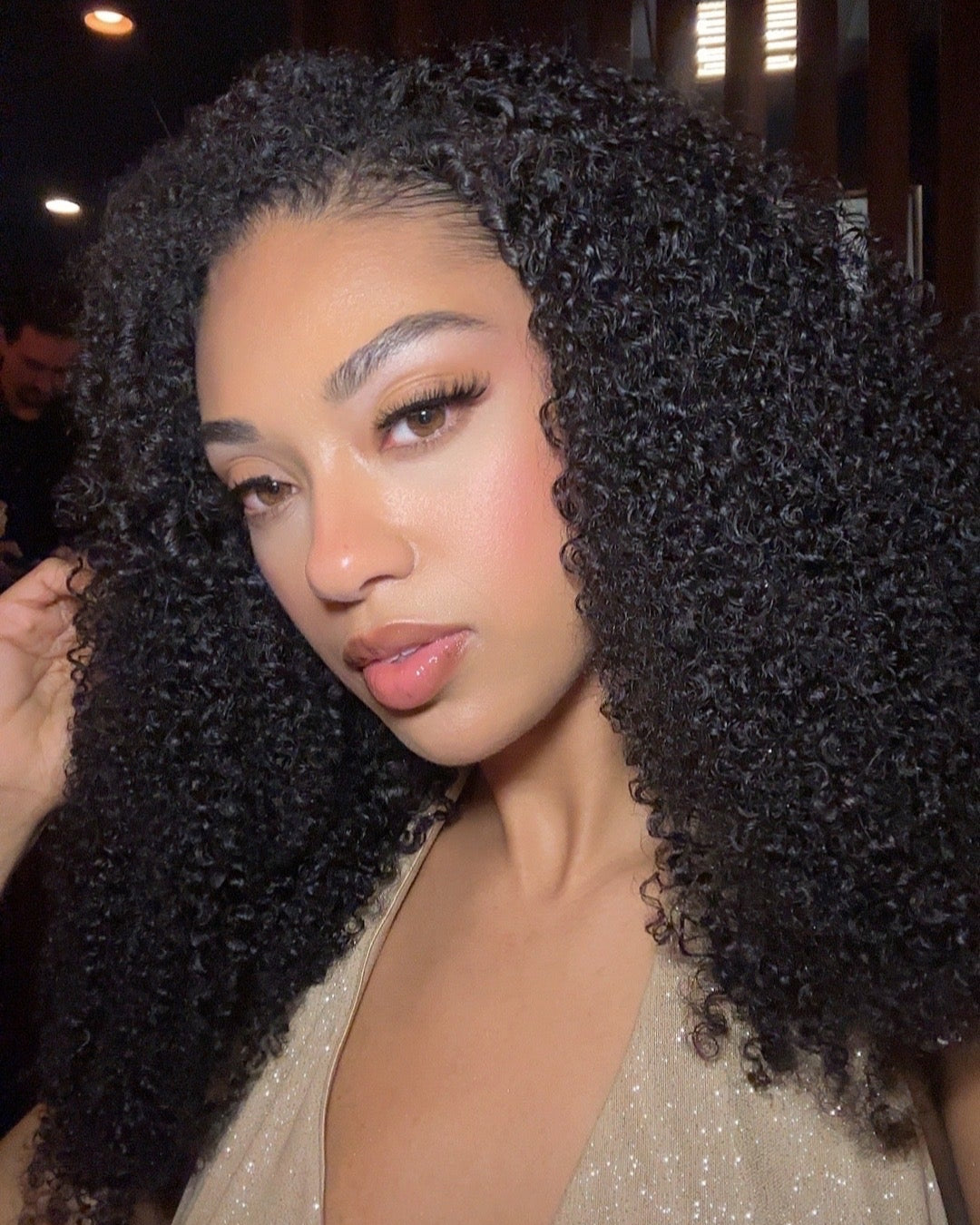 Natural black virgin Brazilian curly bundle laid flat showing full length