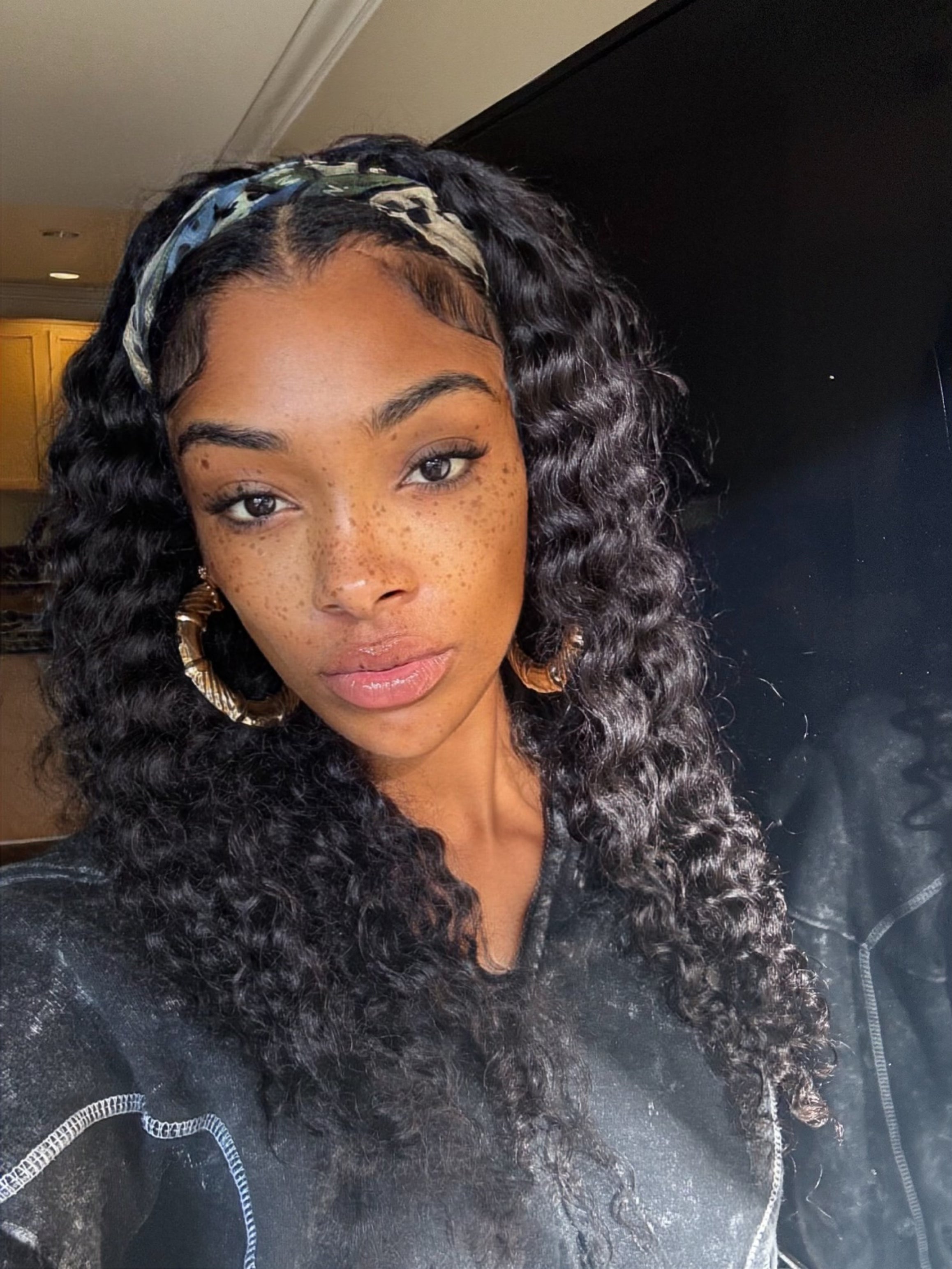 Three natural black Brazilian deep wave bundles stacked for a full sew-in