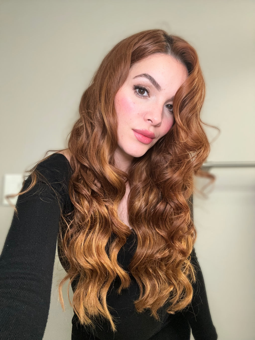 Seamless clip-in extension weft held against the scalp for placement