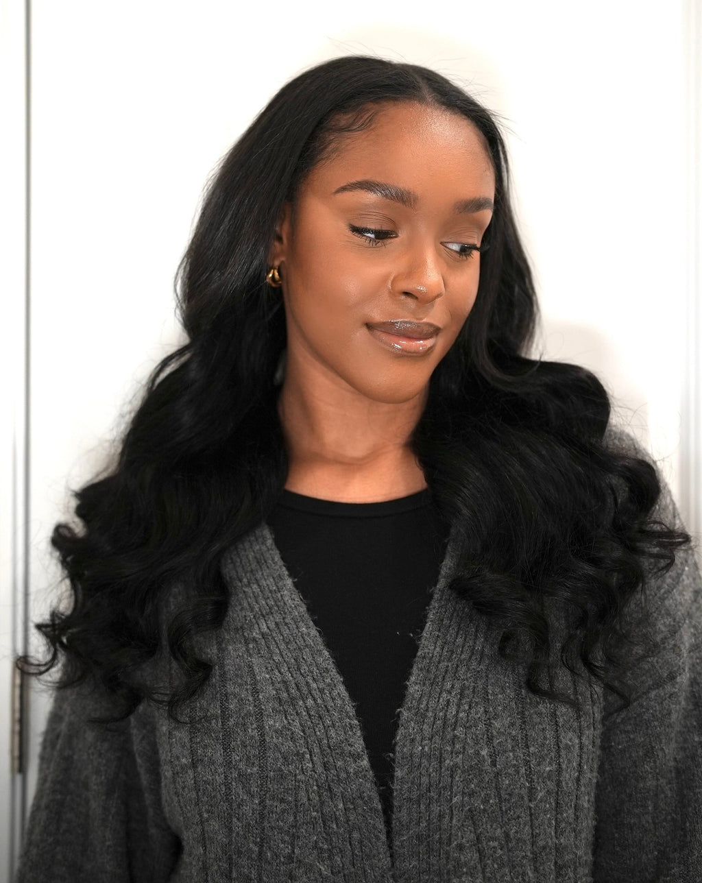 Natural black Malaysian body wave bundle photographed against a plain background