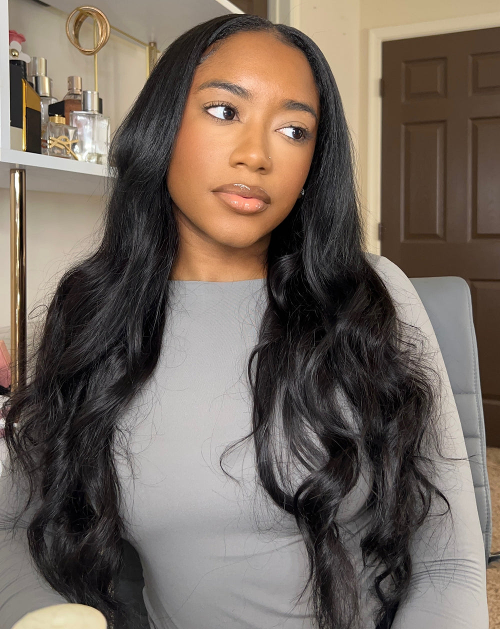 Woman in a grey long-sleeve wearing long straight virgin hair