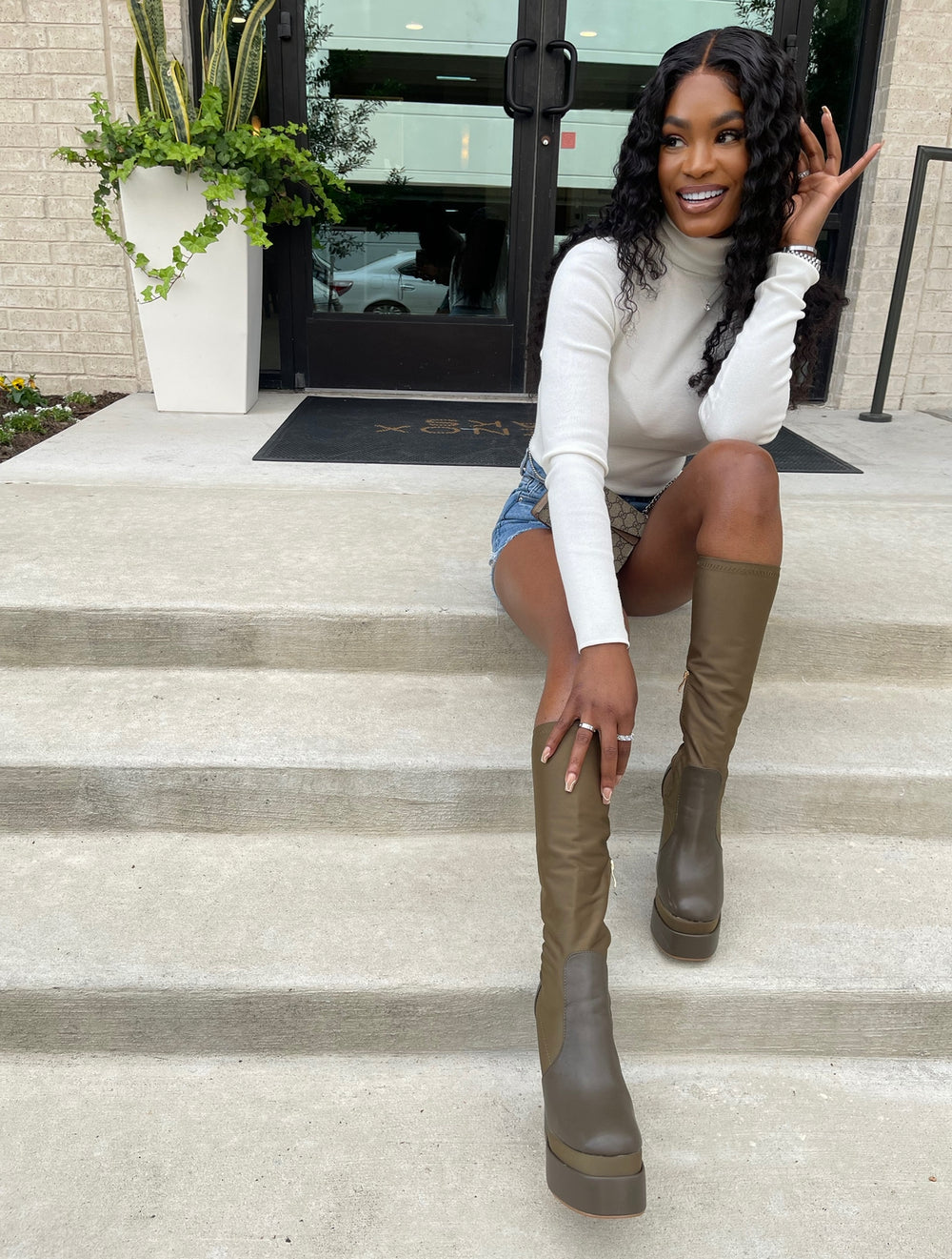 Model wearing a 24 inch HD lace Brazilian deep wave 5x5 closure wig