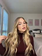 Model with seamless clip-in extensions styled in soft bouncy curls