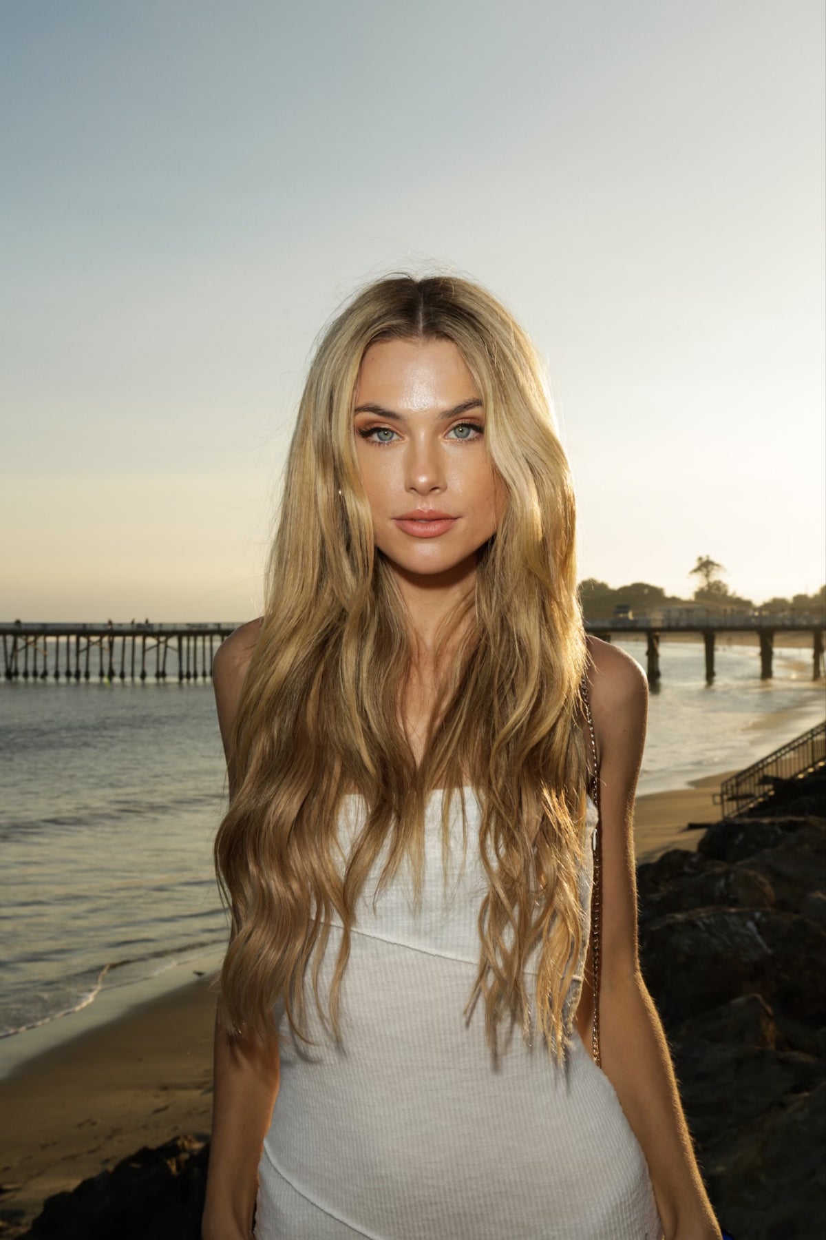 Model wearing seamless clip-in extensions styled in a high ponytail