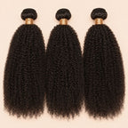 Three Afro kinky curly human hair bundles standing side by side