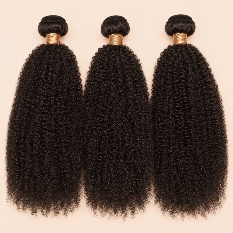 Three Afro kinky curly human hair bundles standing side by side