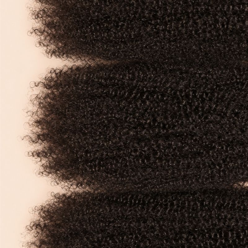 Three Afro kinky curly wefts laid flat, showing the staggered lengths
