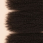 Three Afro kinky curly wefts laid flat, showing the staggered lengths