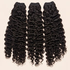 Three Burmese curly human hair bundles standing side by side