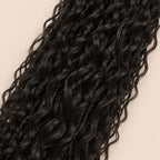 Close-up of deep wave human hair curls woven through a twisted braid