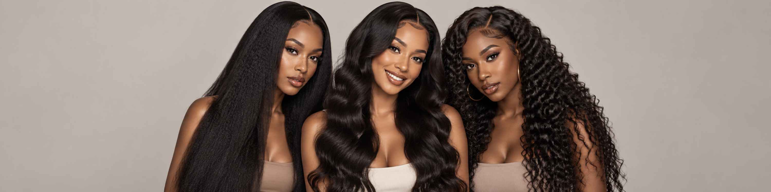 Three women modeling long, dark hair extensions or wigs against a plain light gray studio background. The center woman wears a straight, glossy black extension, the left woman wears a straight, very dark brown extension, and the right woman wears a curly, dark brown extension.