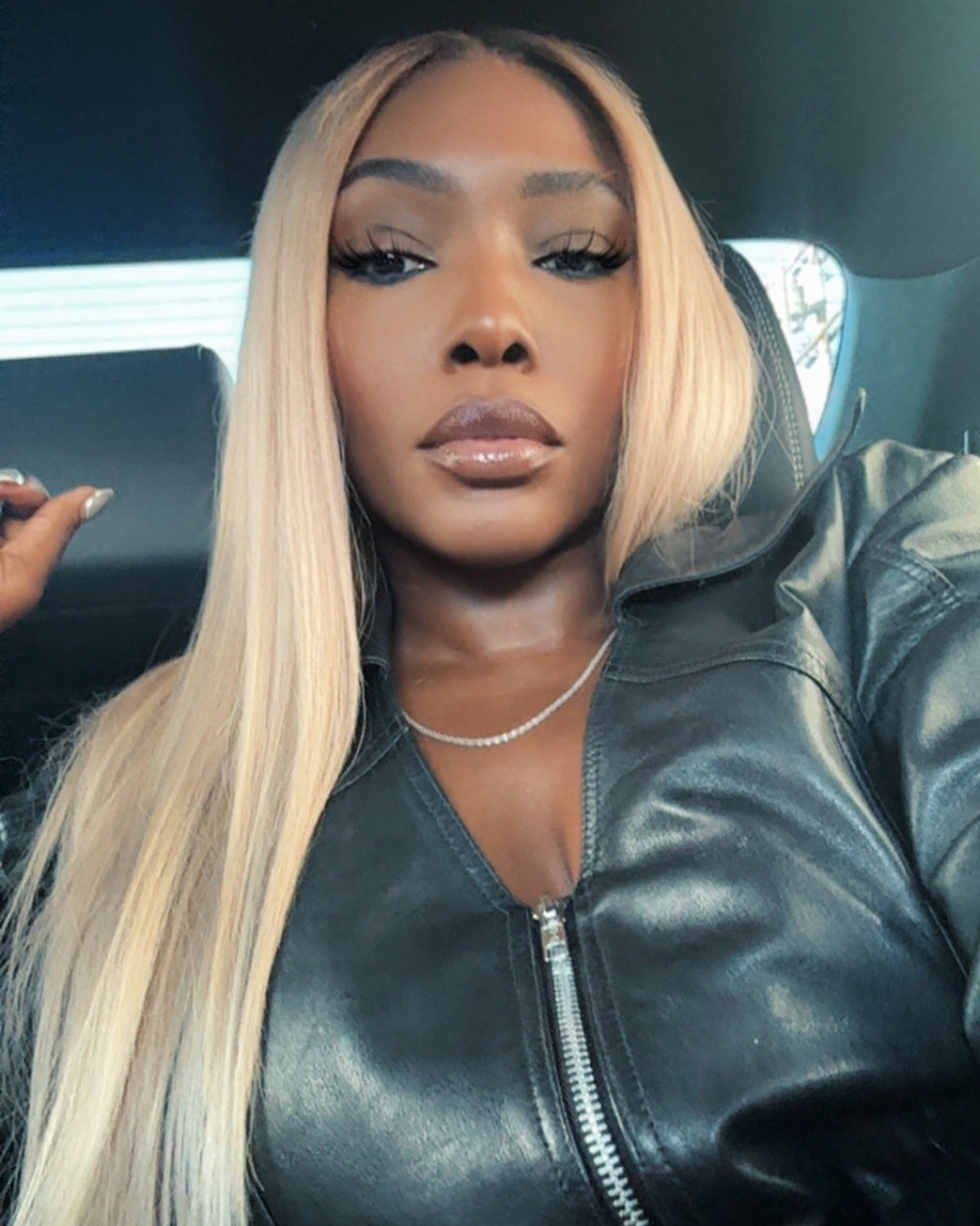 Model wearing a 613 blonde Indian straight sew-in, front view