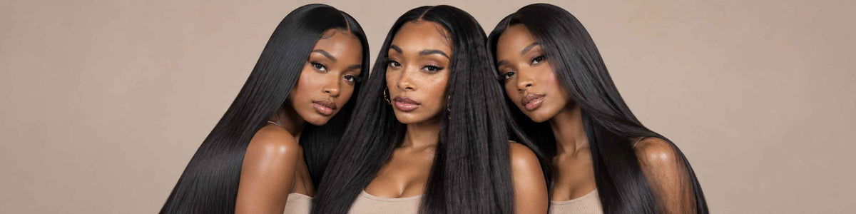 Three women with long, kinky straight, black hair pose together against a solid beige background.