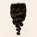 Loose wave 7x7 HD lace closure in natural black, laid flat showing the full hair length
