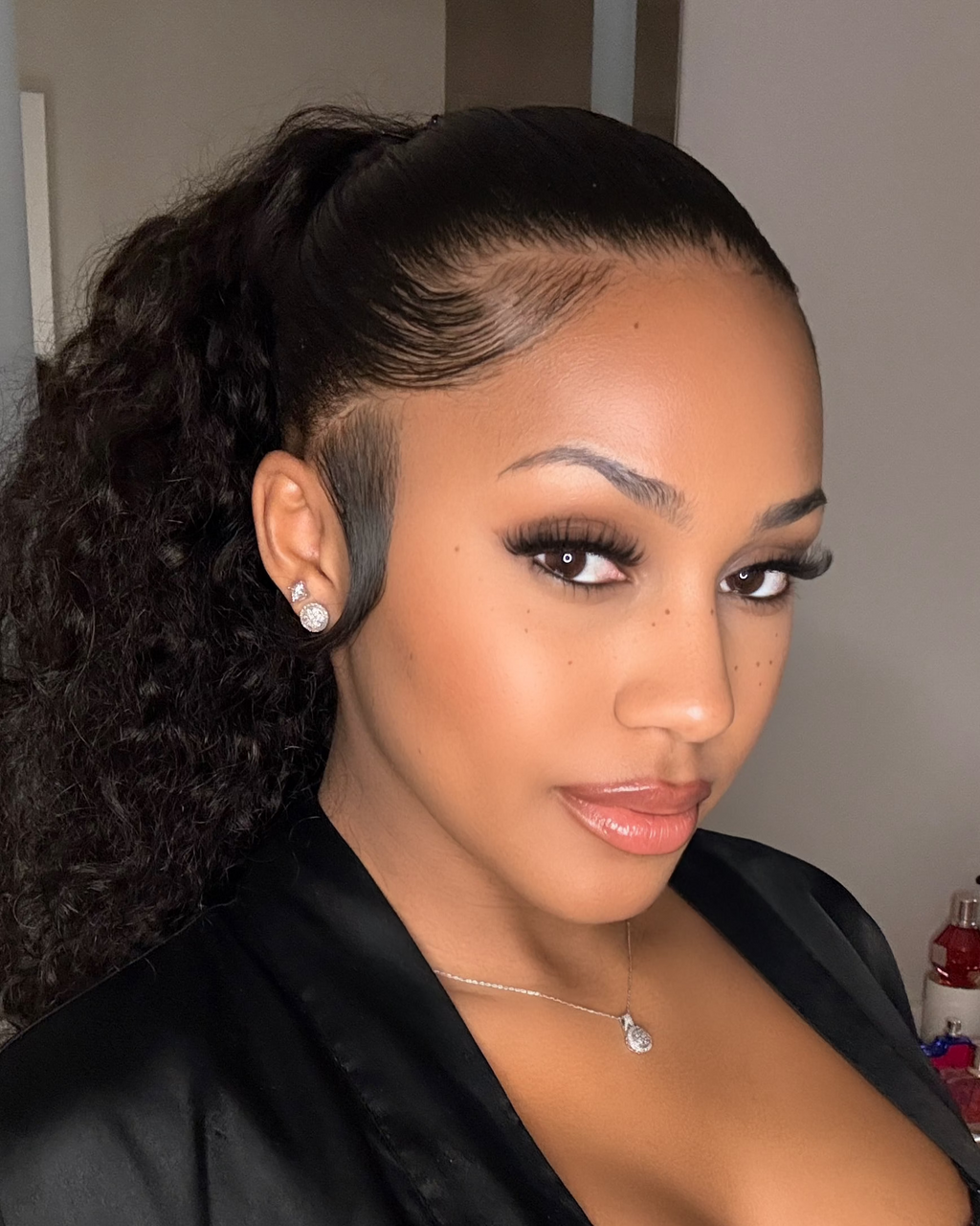 Long natural black Brazilian deep wave install styled with a side part