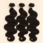 Three raw body wave human hair bundles standing side by side