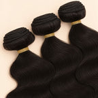 Three raw body wave bundles angled to show the machine-sewn wefts