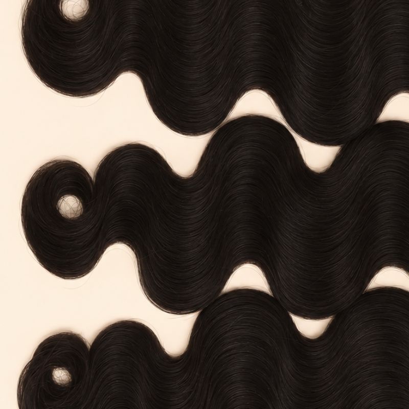 Three raw body wave wefts laid flat, showing the staggered lengths
