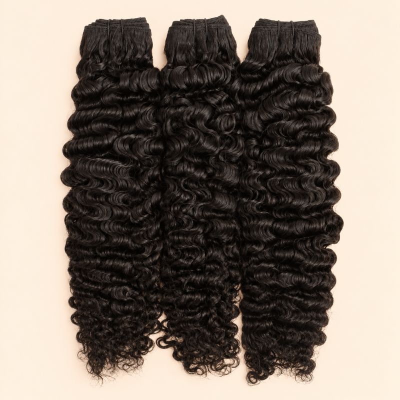 Three raw Burmese curly human hair bundles standing side by side