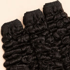 Three raw Burmese curly bundles angled to show the machine-sewn wefts
