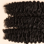 Three raw Burmese curly wefts laid flat, showing the staggered lengths