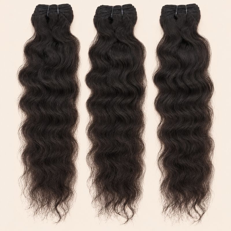 Three raw Indian curly human hair bundles standing side by side