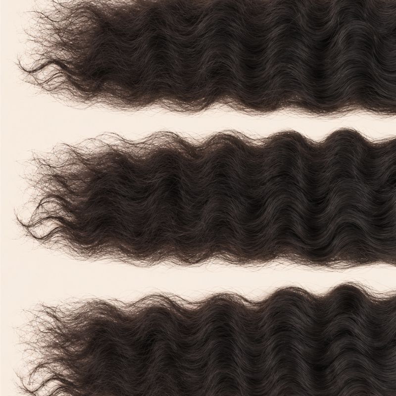 Three raw Indian curly wefts laid flat, showing the staggered lengths